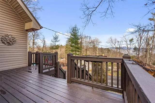 a view of balcony with wooden floor and fence