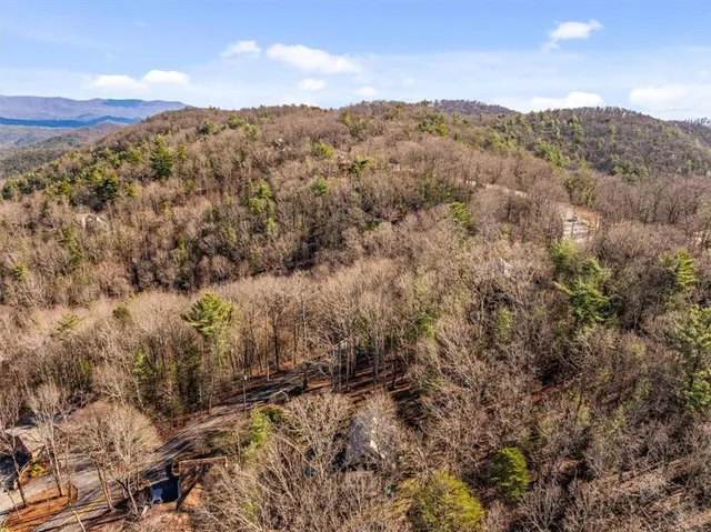a view of a large mountain with mountains in the background