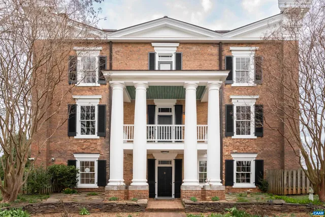 a front view of a residential apartment building with a yard
