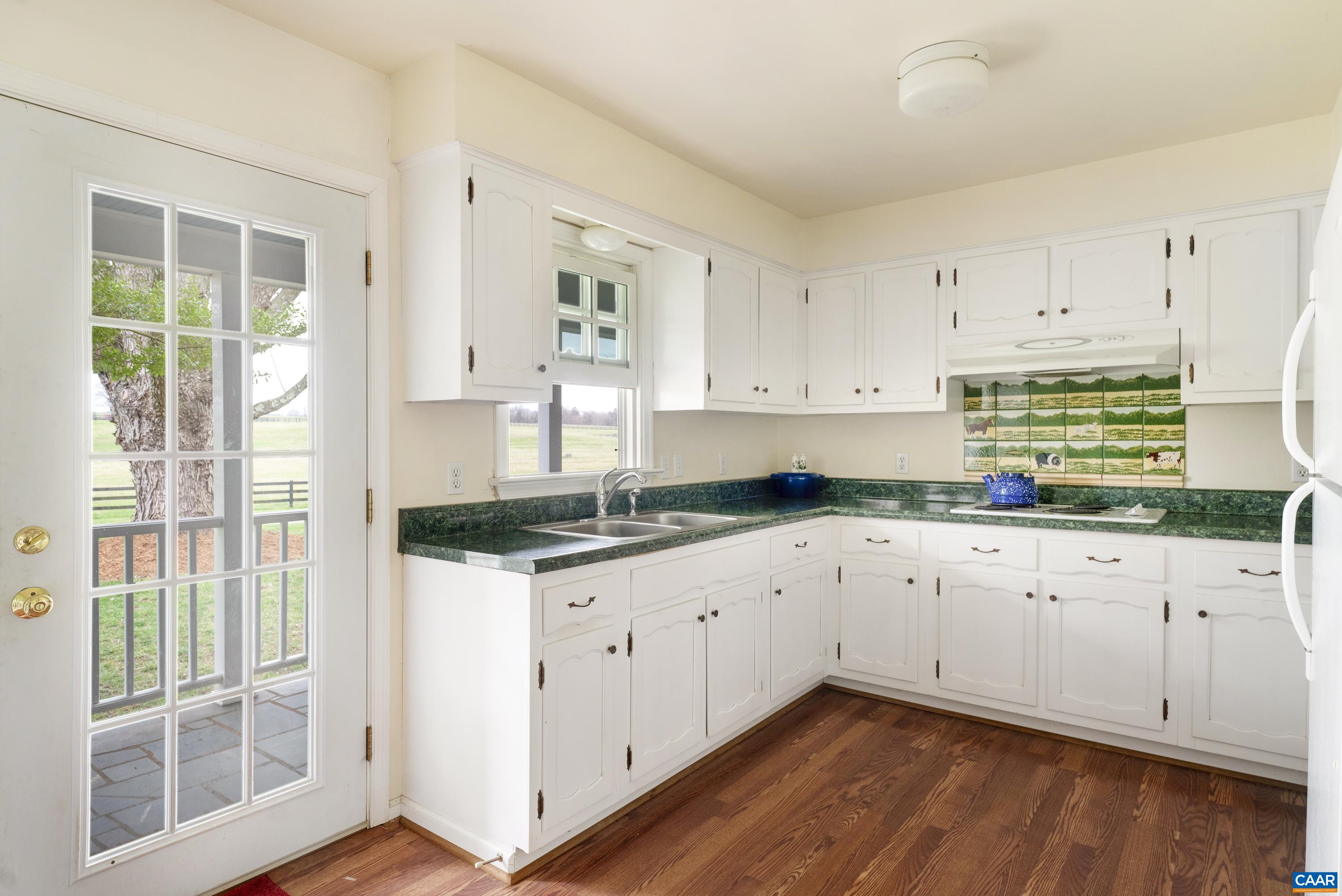 23501 Greenville Road Culpeper, VA 22701 - Photo 63 of 69 a kitchen with granite countertop white cabinets and a sink