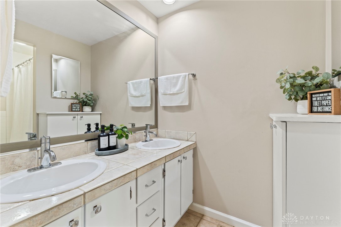 2247 East Whipp Road Dayton, OH 45440 - Photo 33 of 52 This bathroom features a double vanity and sleek countertops, providing ample space and elegant design.