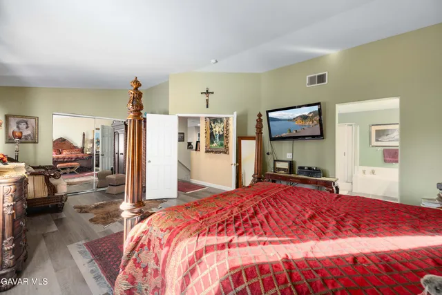 a bed room with a bed and a television