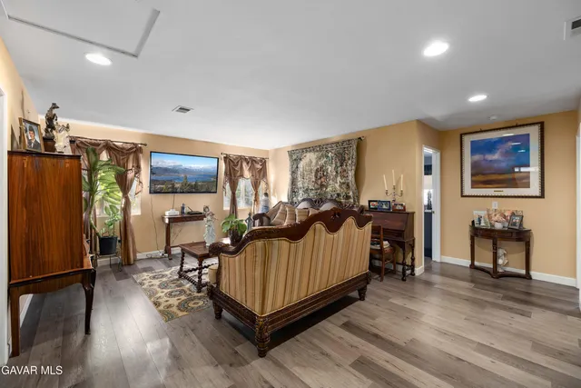 a bedroom with furniture and a flat screen tv
