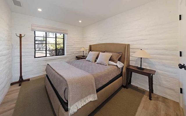 a bedroom with a bed and window