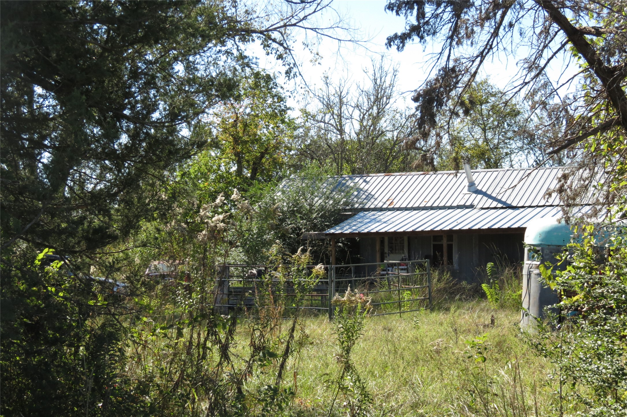 343 Evie Davidson Road Groveton, TX 75845 - Photo 2 of 13 a front view of a house with a garden