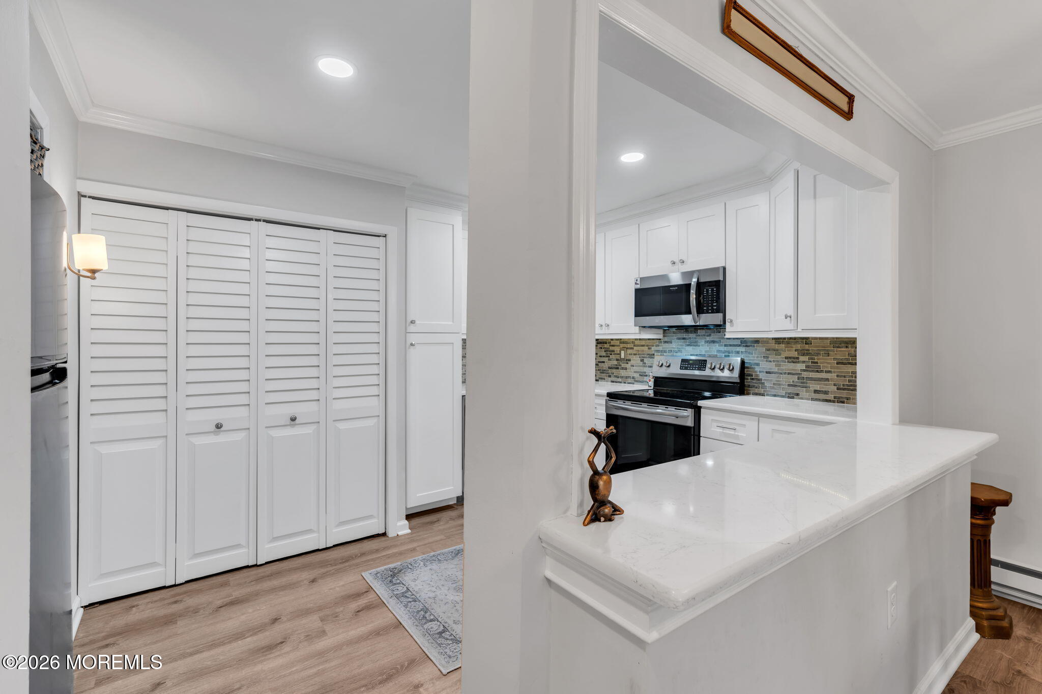 8 Manchester Court Red Bank, NJ 07701 - Photo 11 of 20 a kitchen with granite countertop white cabinets and stainless steel appliances