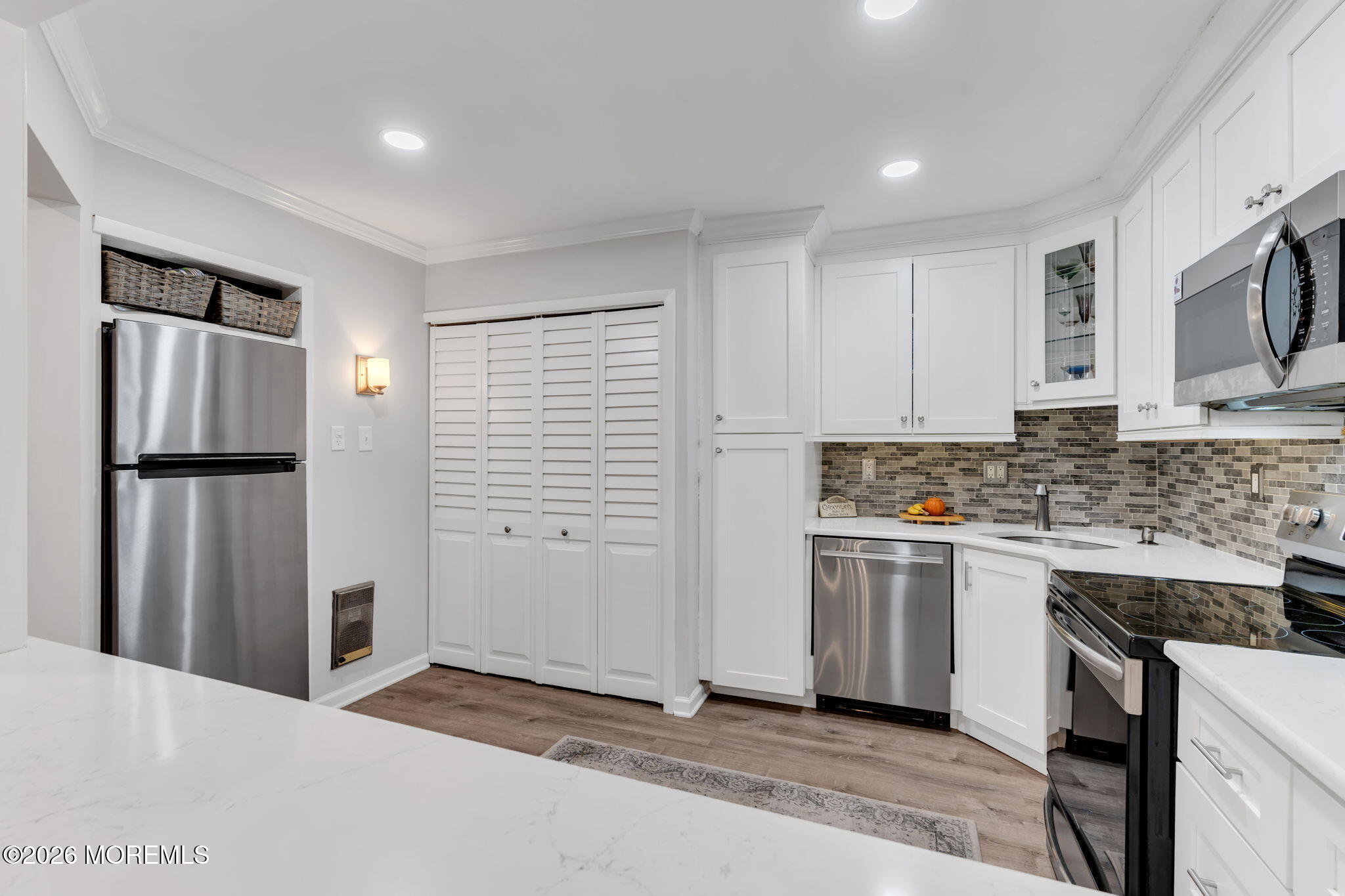8 Manchester Court Red Bank, NJ 07701 - Photo 12 of 20 a kitchen with stainless steel appliances granite countertop a refrigerator sink and stove