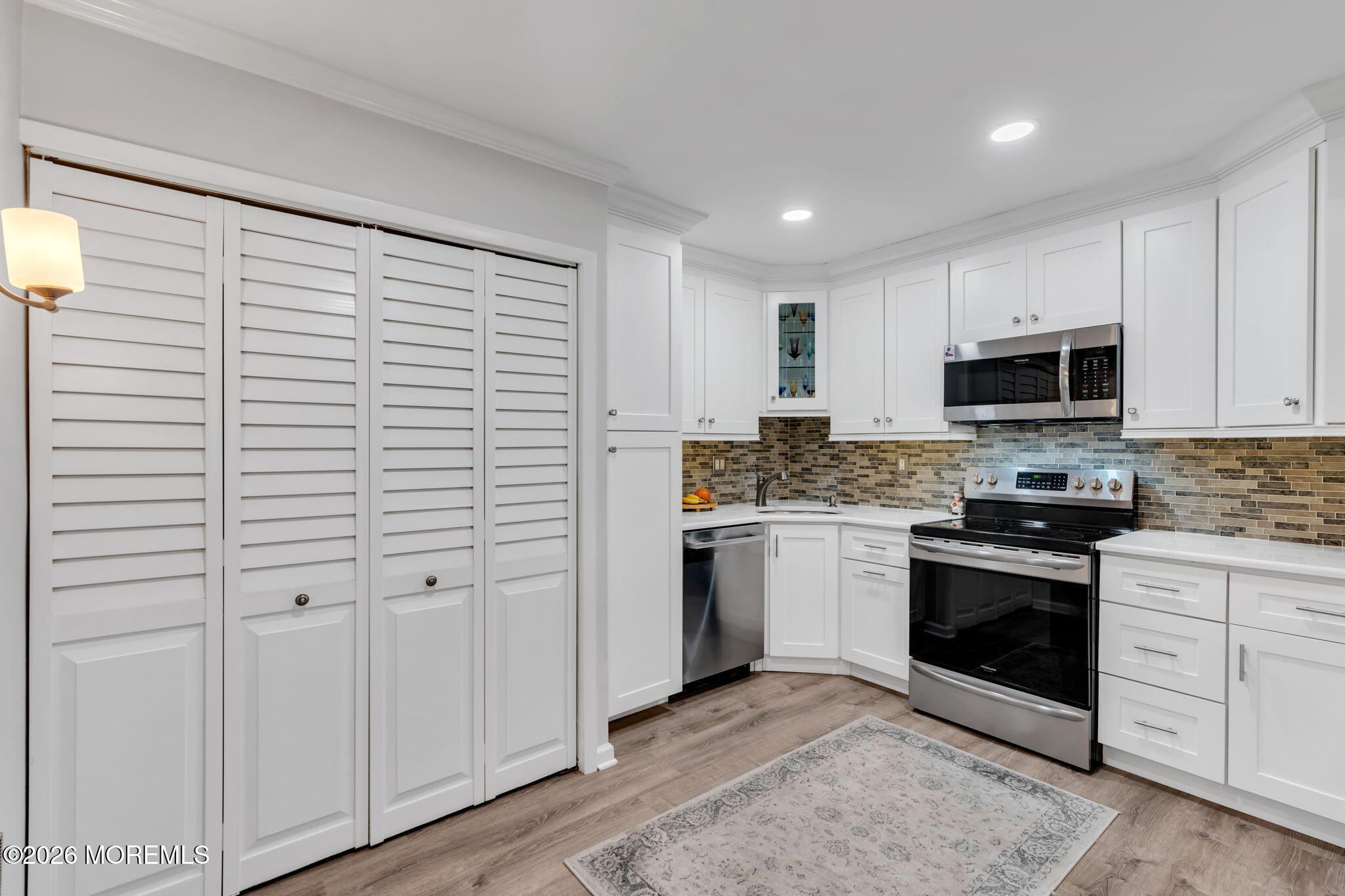 8 Manchester Court Red Bank, NJ 07701 - Photo 15 of 20 a kitchen with a sink and white cabinets
