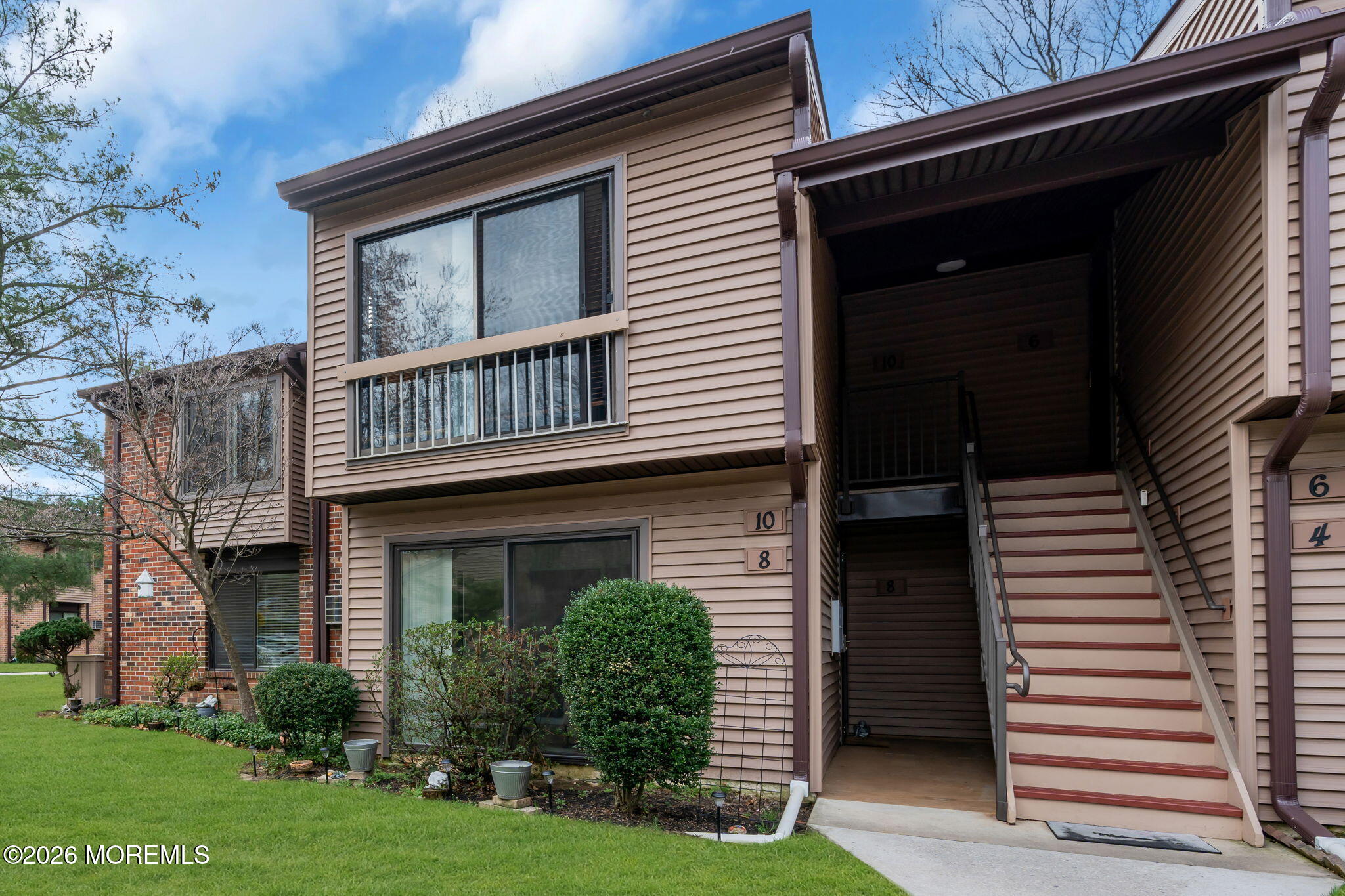8 Manchester Court Red Bank, NJ 07701 - Photo 5 of 20 a view of a house with brick walls and a small yard