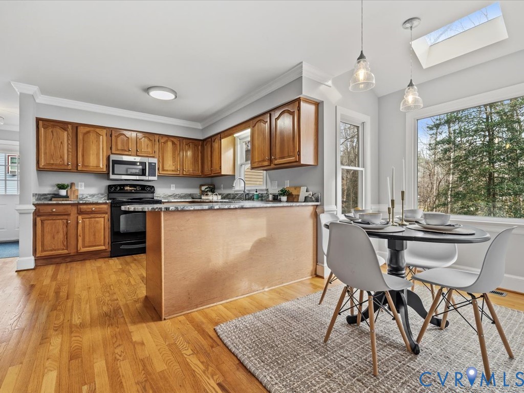 10221 North Donegal Road Chesterfield, VA 23832 - Photo 15 of 41 a kitchen with stainless steel appliances granite countertop a stove top oven a sink dishwasher a dining table and chairs with wooden floor