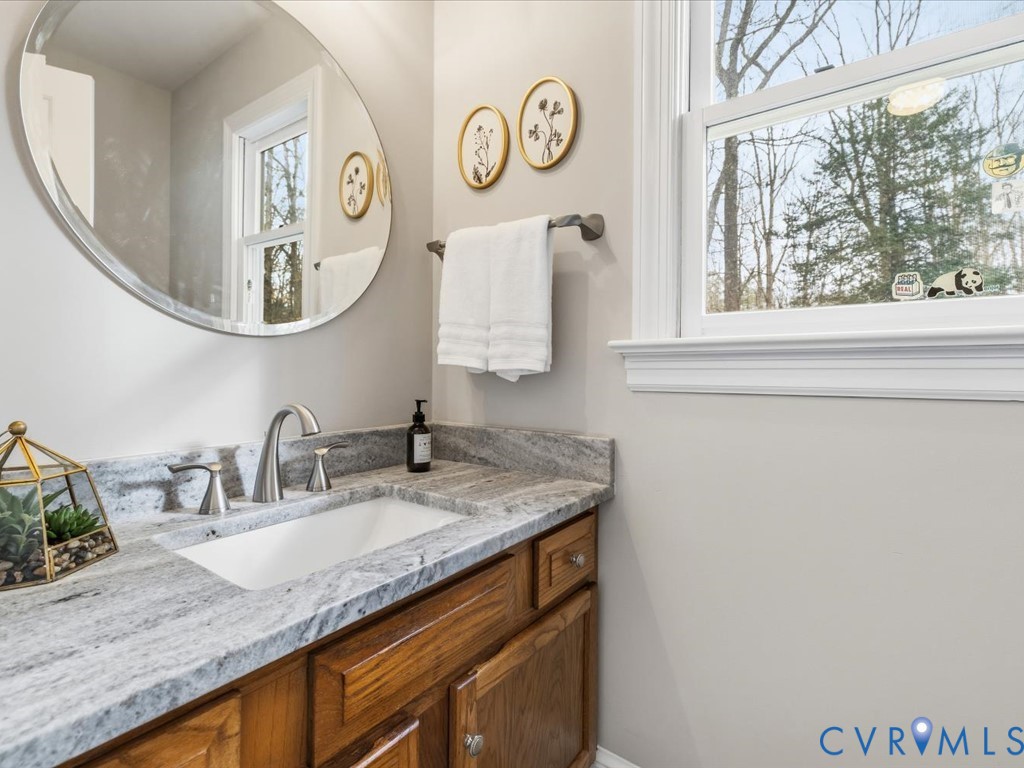 10221 North Donegal Road Chesterfield, VA 23832 - Photo 16 of 41 a bathroom with a granite countertop sink and a mirror