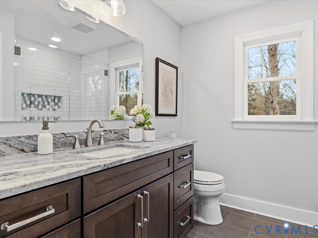 10221 North Donegal Road Chesterfield, VA 23832 - Photo 24 of 41 a bathroom with a granite countertop toilet sink and mirror