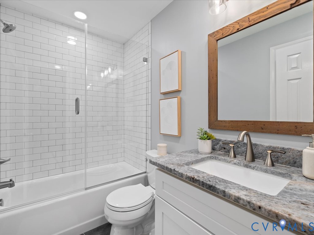10221 North Donegal Road Chesterfield, VA 23832 - Photo 29 of 41 a bathroom with a granite countertop sink a toilet and bathtub