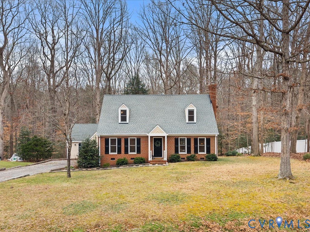 10221 North Donegal Road Chesterfield, VA 23832 - Photo 37 of 41 a front view of a house with a yard covered with snow and trees