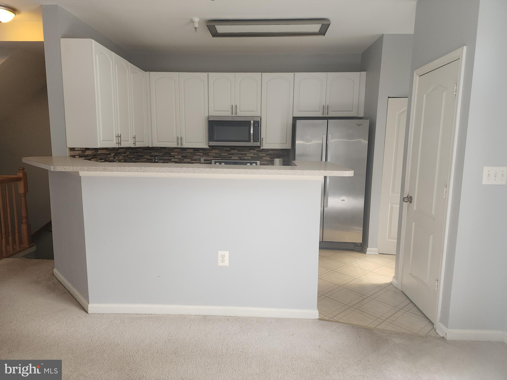 556 Rhapsody Court Hunt Valley, MD 21030 - Photo 14 of 38 a view of kitchen with granite countertop cabinets and refrigerator
