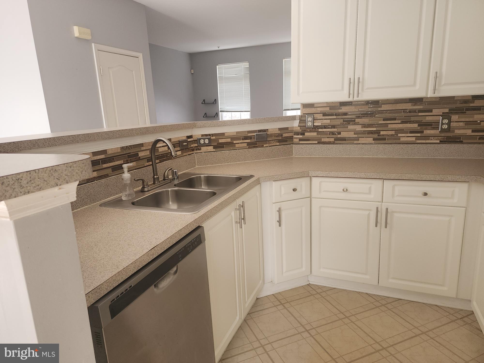 556 Rhapsody Court Hunt Valley, MD 21030 - Photo 15 of 38 a kitchen with a sink and cabinets