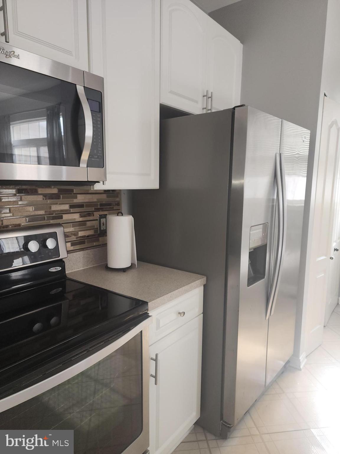 556 Rhapsody Court Hunt Valley, MD 21030 - Photo 16 of 38 a kitchen with stainless steel appliances granite countertop a refrigerator and a stove