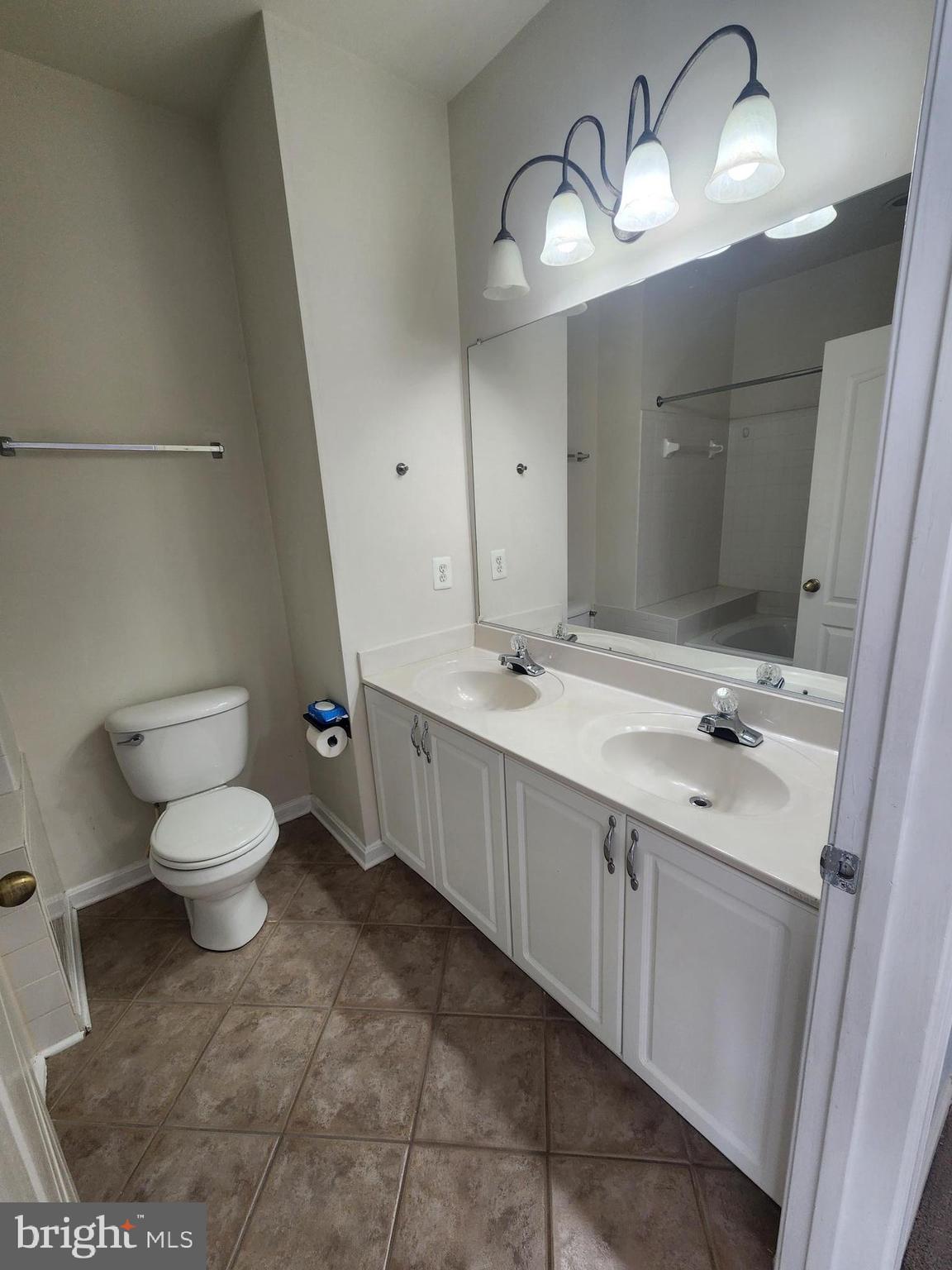 556 Rhapsody Court Hunt Valley, MD 21030 - Photo 28 of 38 a bathroom with a double vanity sink and a toilet