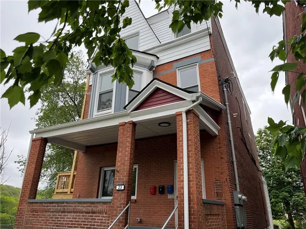 a view of a house with a tree