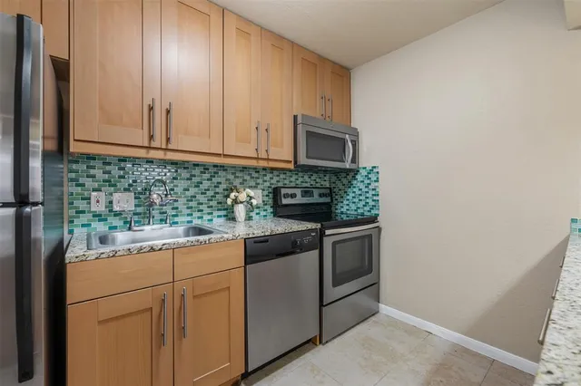 a view of a kitchen with a sink and a fireplace