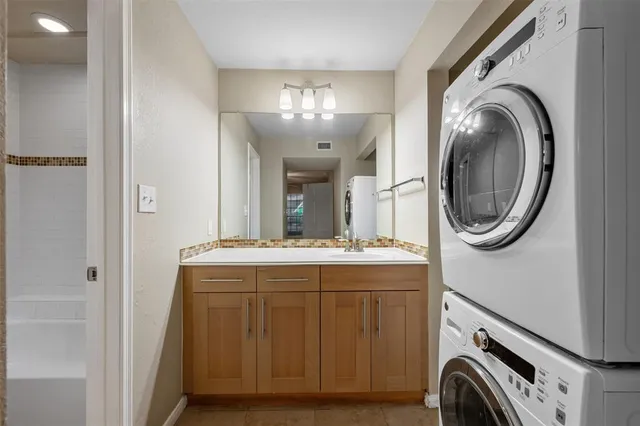 a bathroom with a sink a washer and dryer