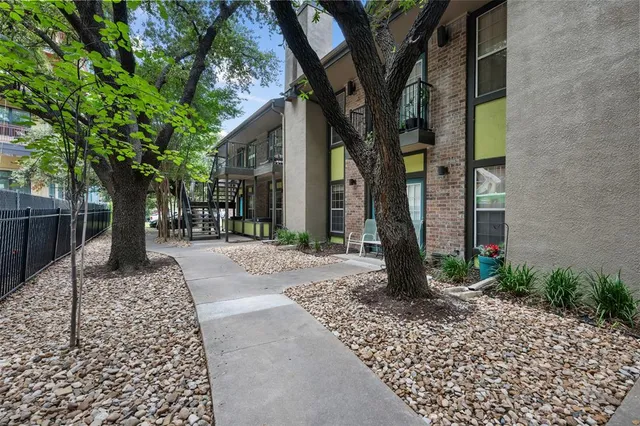 a view of a brick wall with potted plants