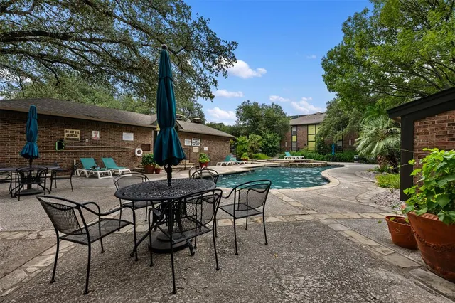 a view of a house with swimming pool and sitting area