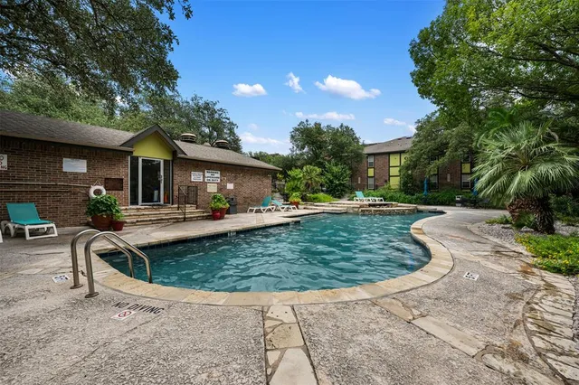 a view of a house with swimming pool and sitting area