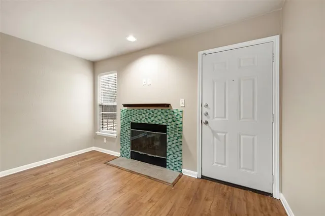 a view of an empty room with furniture and a fireplace
