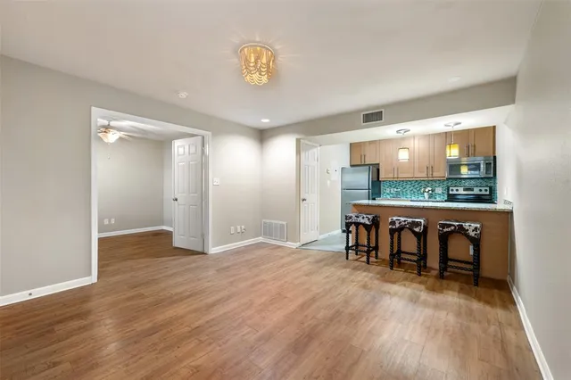 a kitchen with stainless steel appliances granite countertop a stove refrigerator sink and cabinets