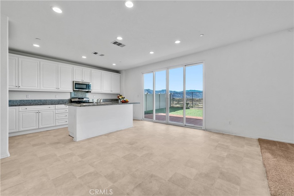 29157 Sunforest Lake Elsinore, CA 92530 - Photo 14 of 39 a kitchen with stainless steel appliances granite countertop a stove a sink and a refrigerator