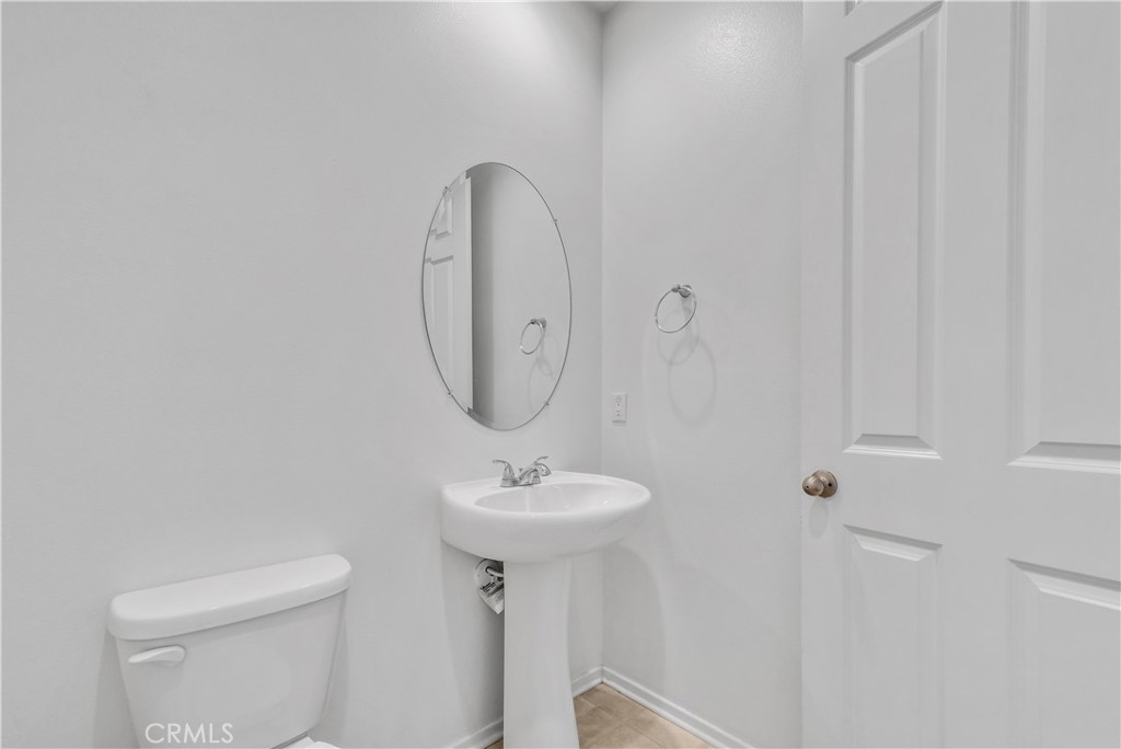 29157 Sunforest Lake Elsinore, CA 92530 - Photo 16 of 39 a bathroom with a sink toilet and a mirror