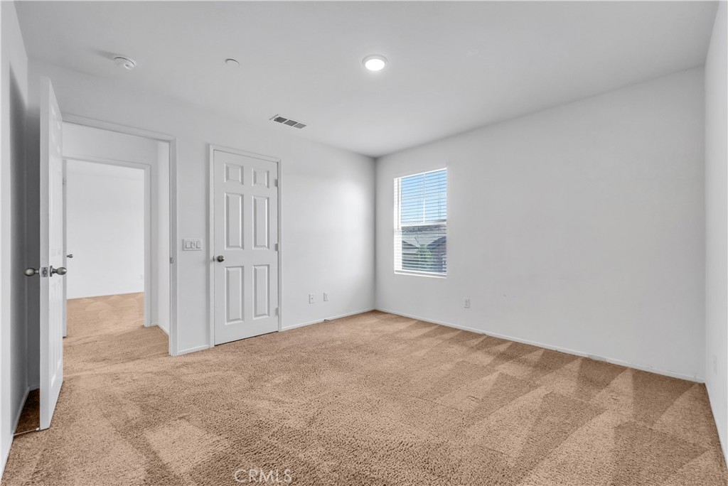 29157 Sunforest Lake Elsinore, CA 92530 - Photo 27 of 39 an empty room with windows and closet