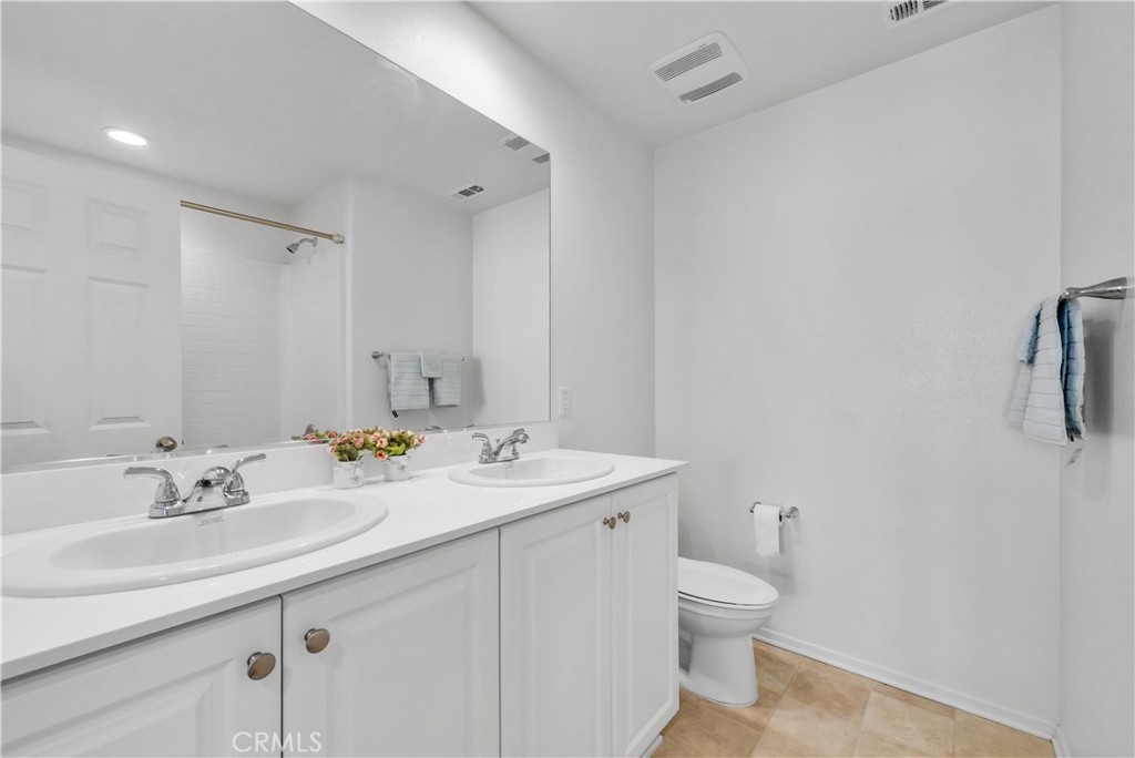 29157 Sunforest Lake Elsinore, CA 92530 - Photo 31 of 39 a bathroom with a sink a toilet and mirror