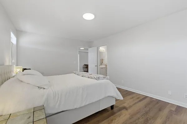 a bedroom with a bed and a night stand