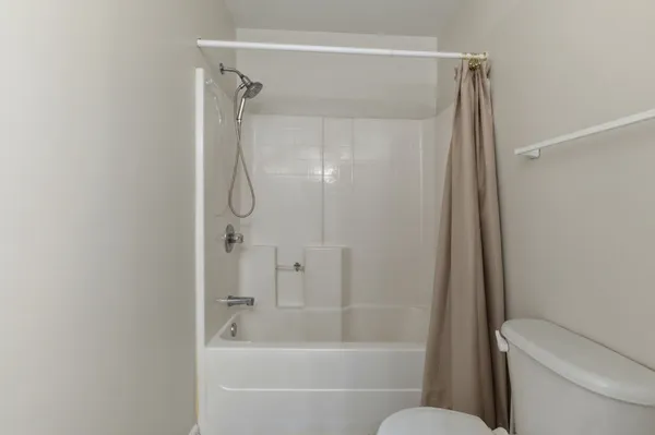 a bathroom with a shower and a toilet