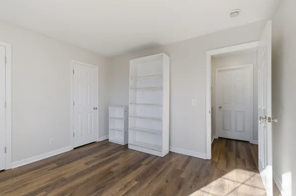 an empty room with wooden floor