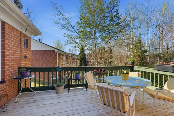 a view of a deck with two chair and wooden floor