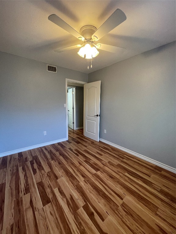1303 Pendergrass Street Lockhart, TX 78644 - Photo 11 of 16 wooden floor in an empty room with a chandelier