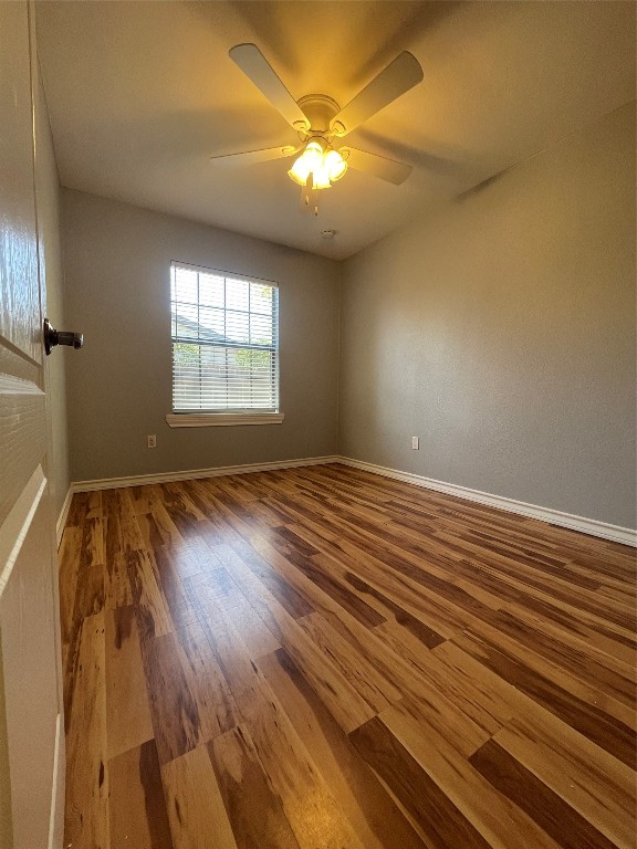 1303 Pendergrass Street Lockhart, TX 78644 - Photo 12 of 16 wooden floor in an empty room with a window