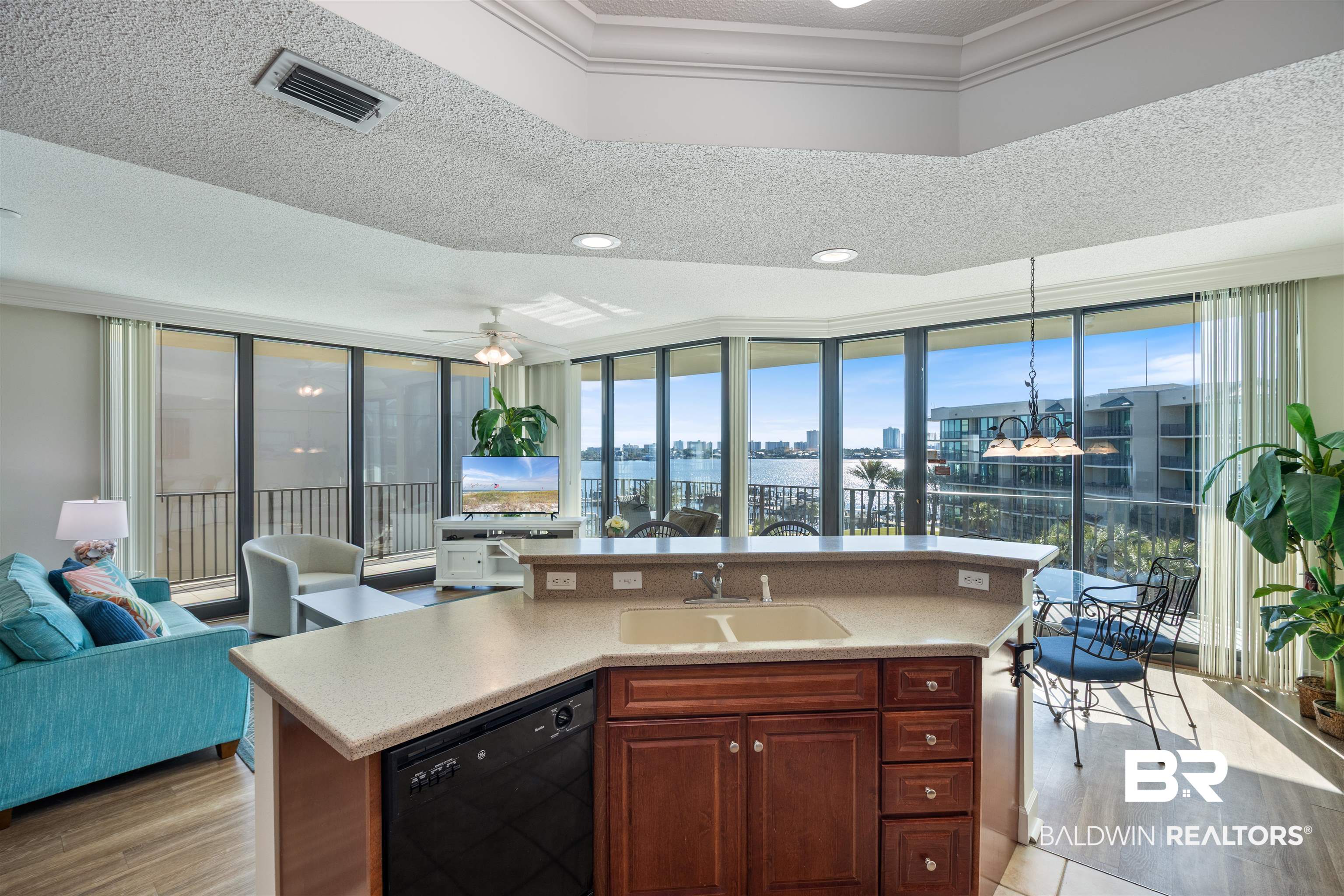 27580 Canal Road, Unit 1431 Orange Beach, AL 36561 - Photo 73 of 73 Kitchen featuring dishwasher, floor to ceiling windows, open floor plan, a textured ceiling, and healthy amount of natural light