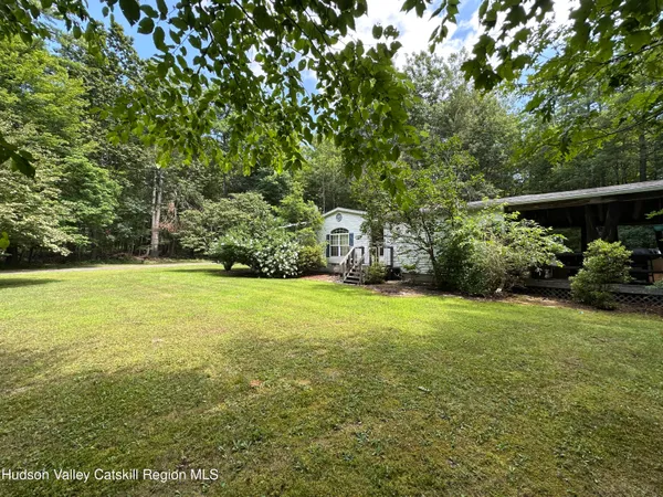 a view of outdoor space with deck and yard