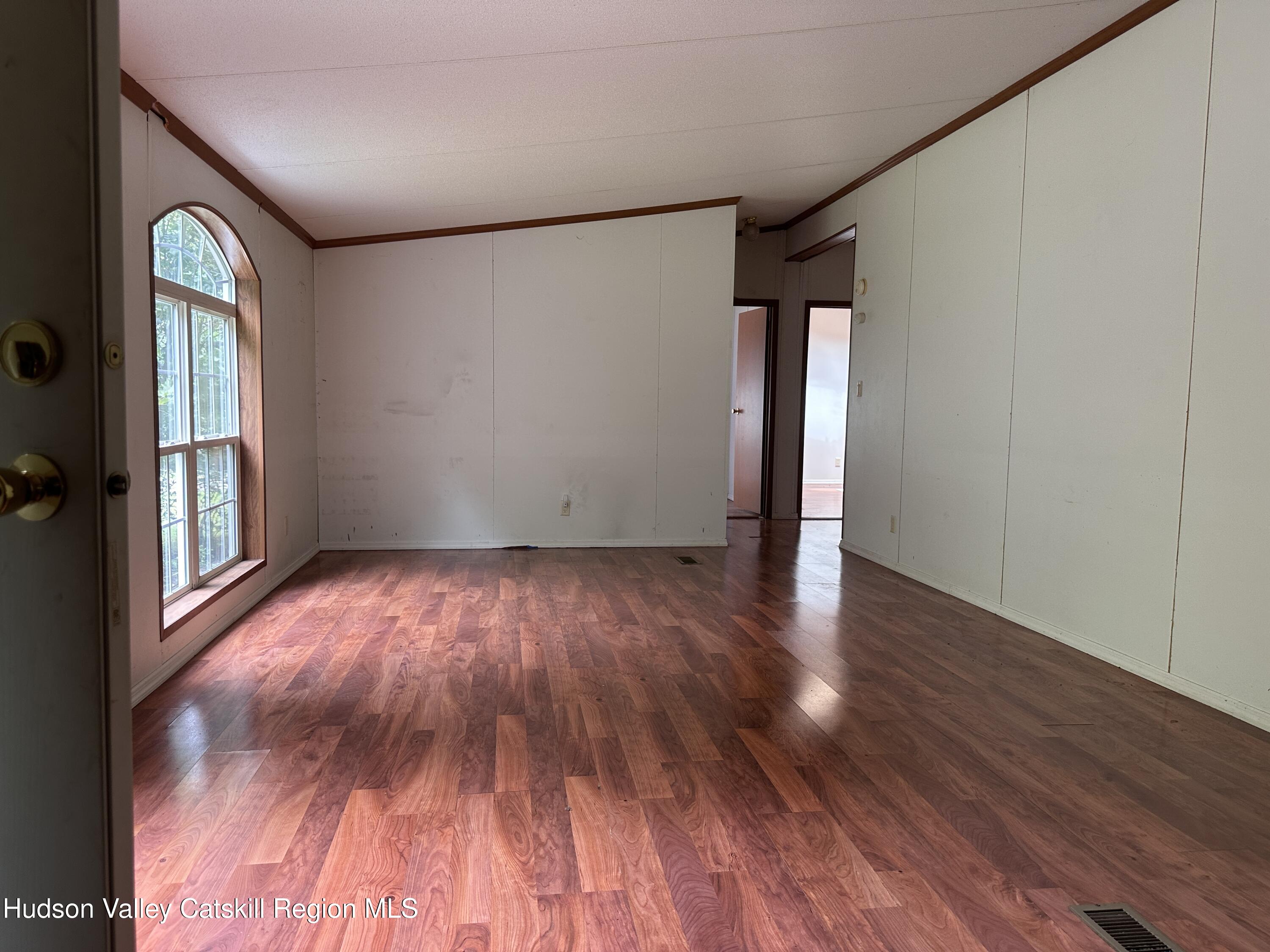 166 Falls View Lane Purling, NY 12470 - Photo 18 of 26 a view of empty room with wooden floor and fan