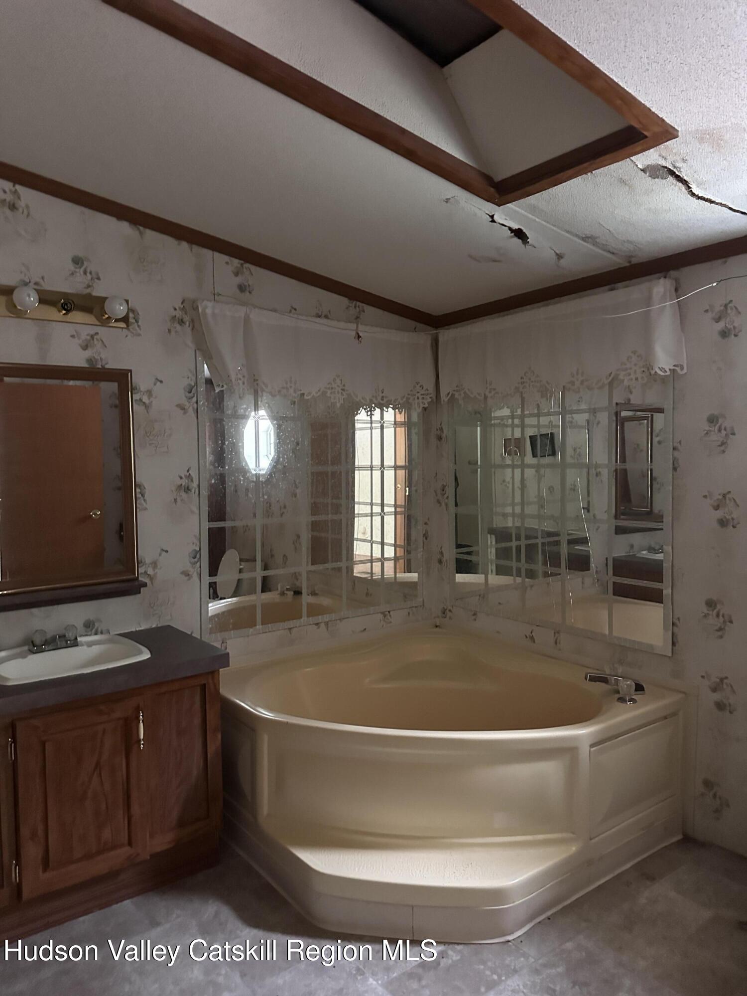 166 Falls View Lane Purling, NY 12470 - Photo 24 of 26 a bath tub sitting next to a bathroom sink