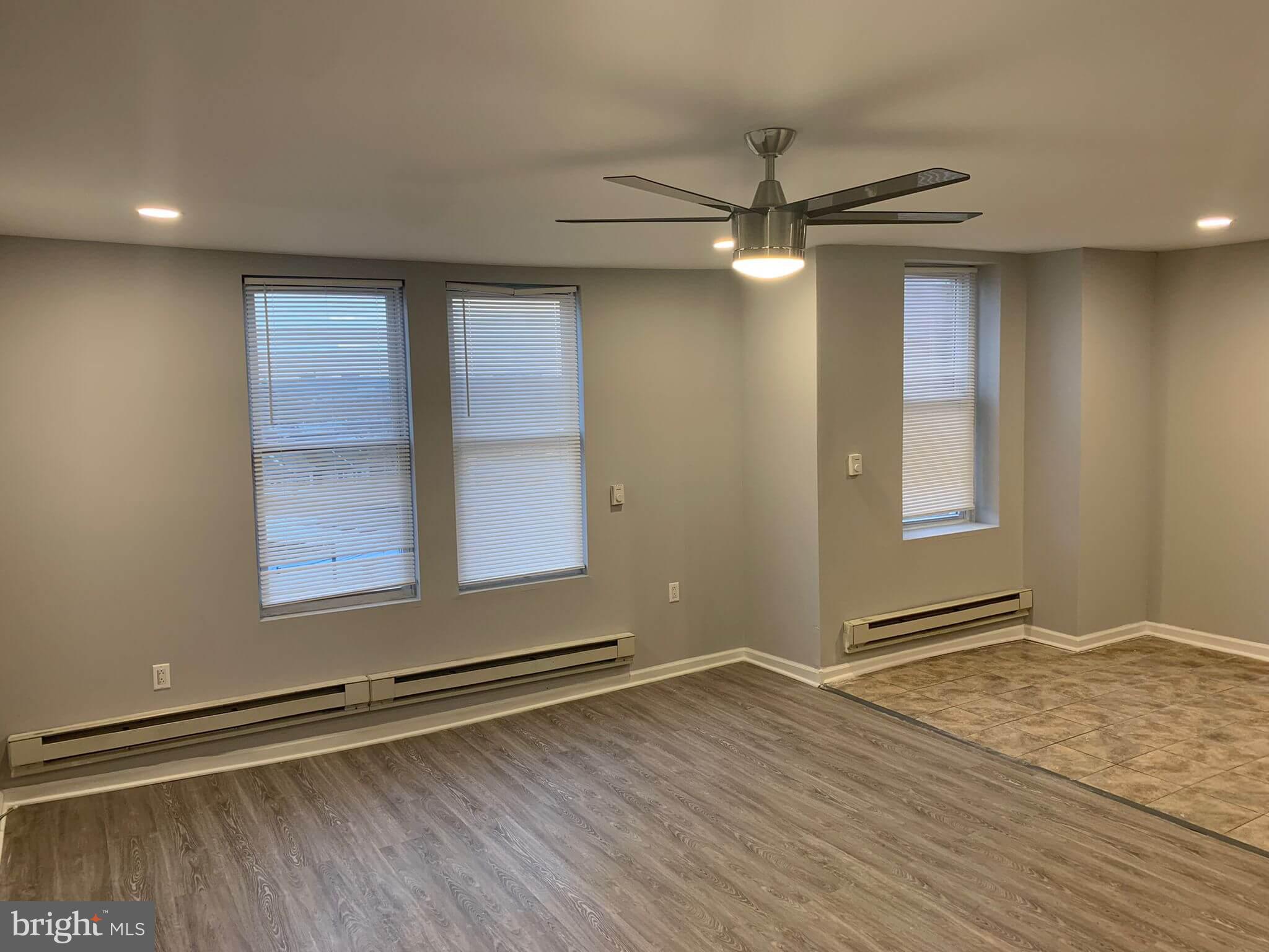 6001 North 17th Street, Unit 404 Philadelphia, PA 19141 - Photo 3 of 11 a view of an empty room with a window and wooden floor