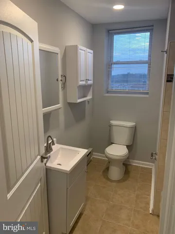 a white toilet sitting next to a bathroom sink