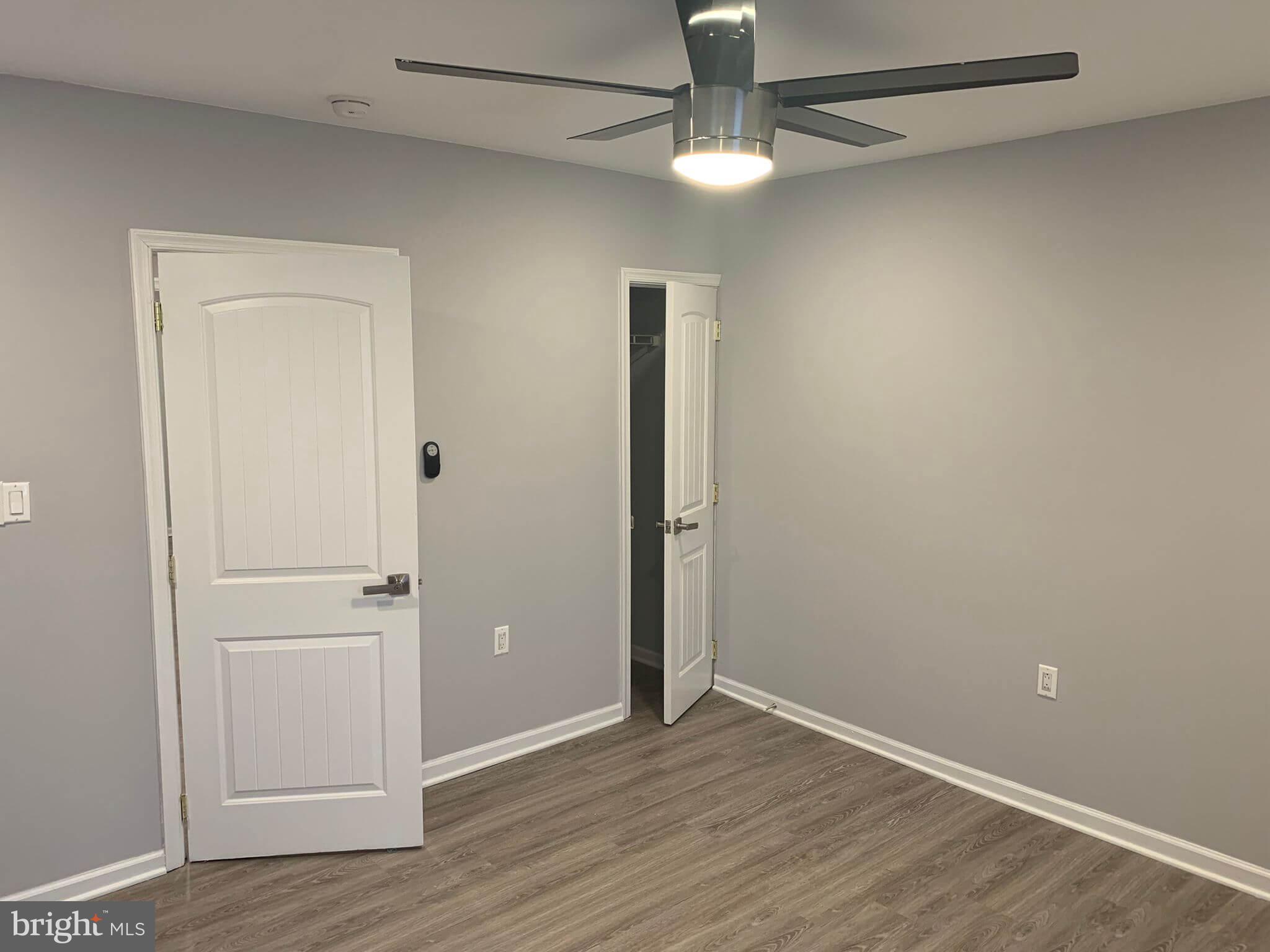 6001 North 17th Street, Unit 404 Philadelphia, PA 19141 - Photo 8 of 11 an empty room with wooden floor closet and windows