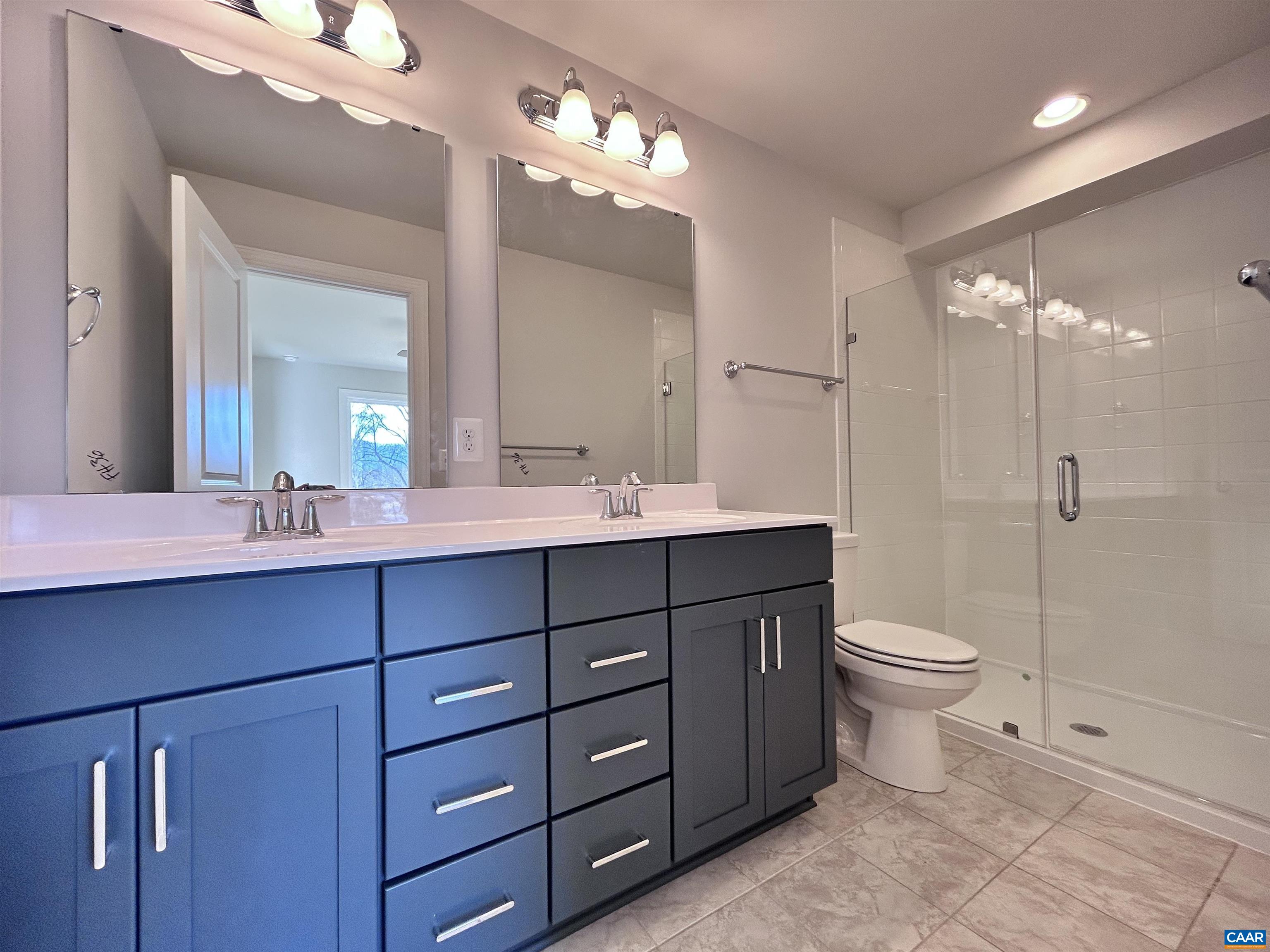 103 Keene Court Charlottesville, VA 22903 - Photo 13 of 18 a bathroom with a double vanity sink a toilet and a mirror
