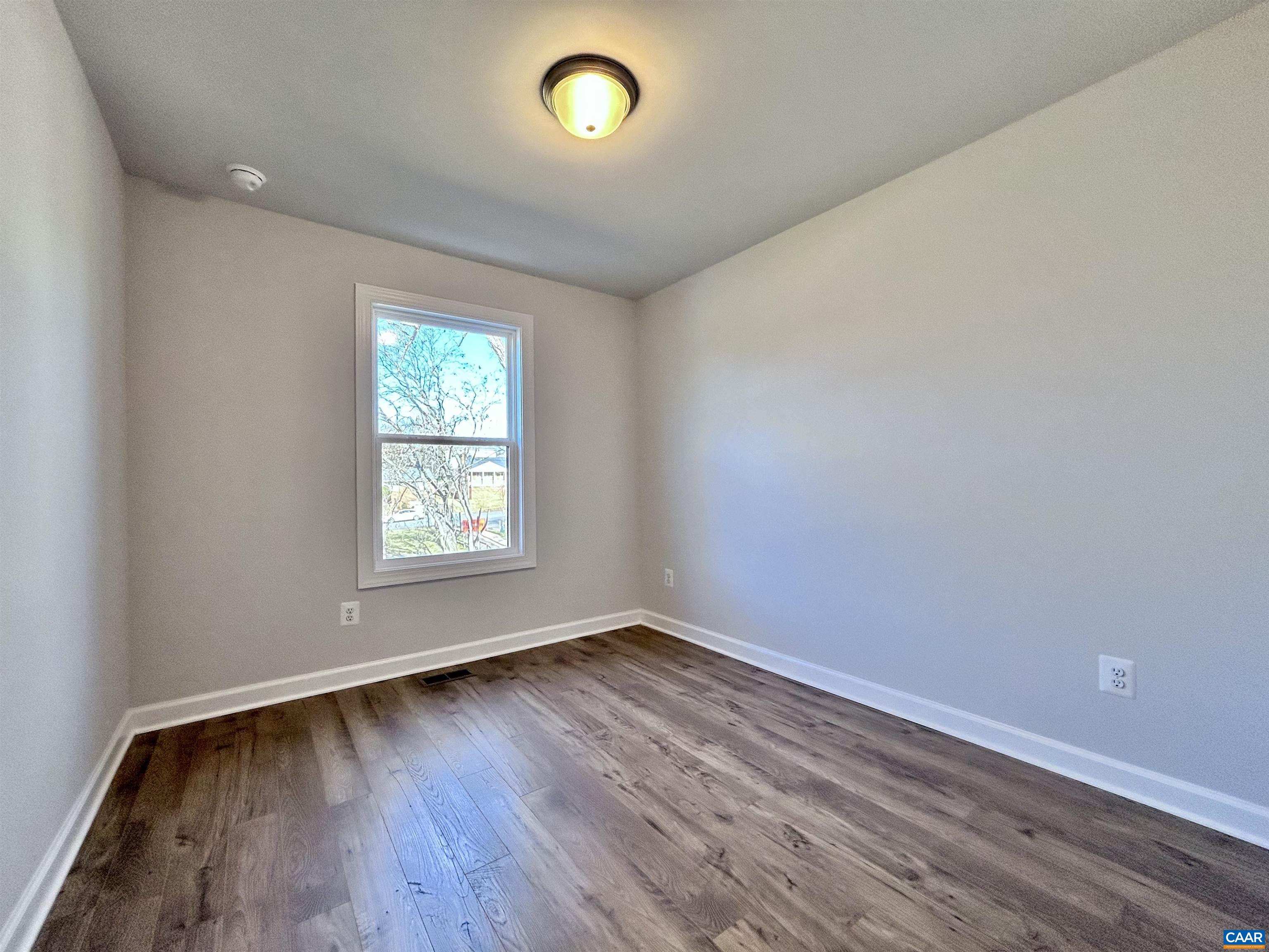 103 Keene Court Charlottesville, VA 22903 - Photo 14 of 18 an empty room with wooden floor and windows