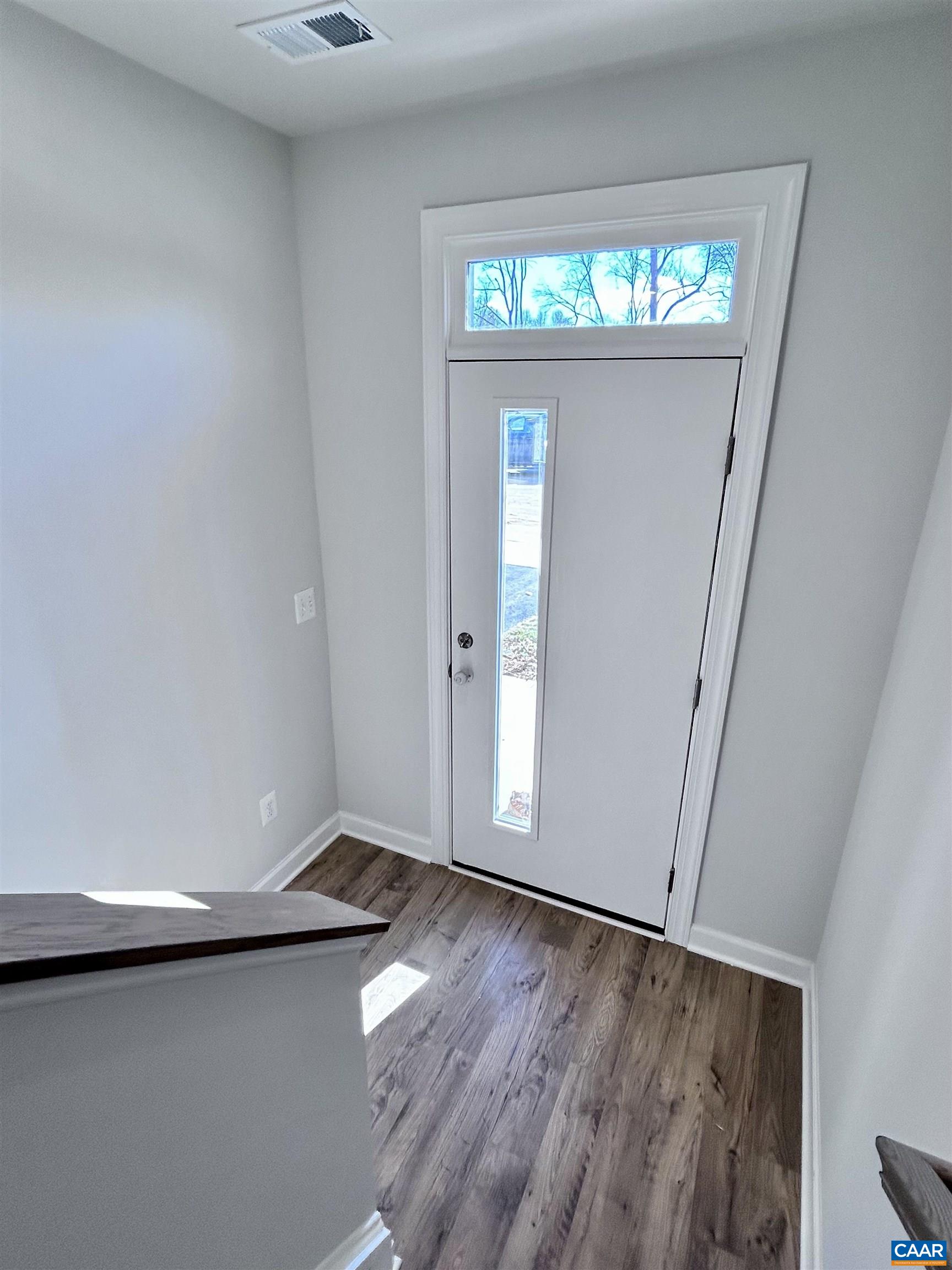 103 Keene Court Charlottesville, VA 22903 - Photo 3 of 18 an empty room with wooden floor fan and windows